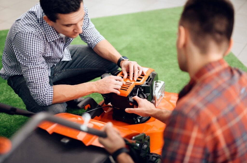 A man starts a lawn mower motor.